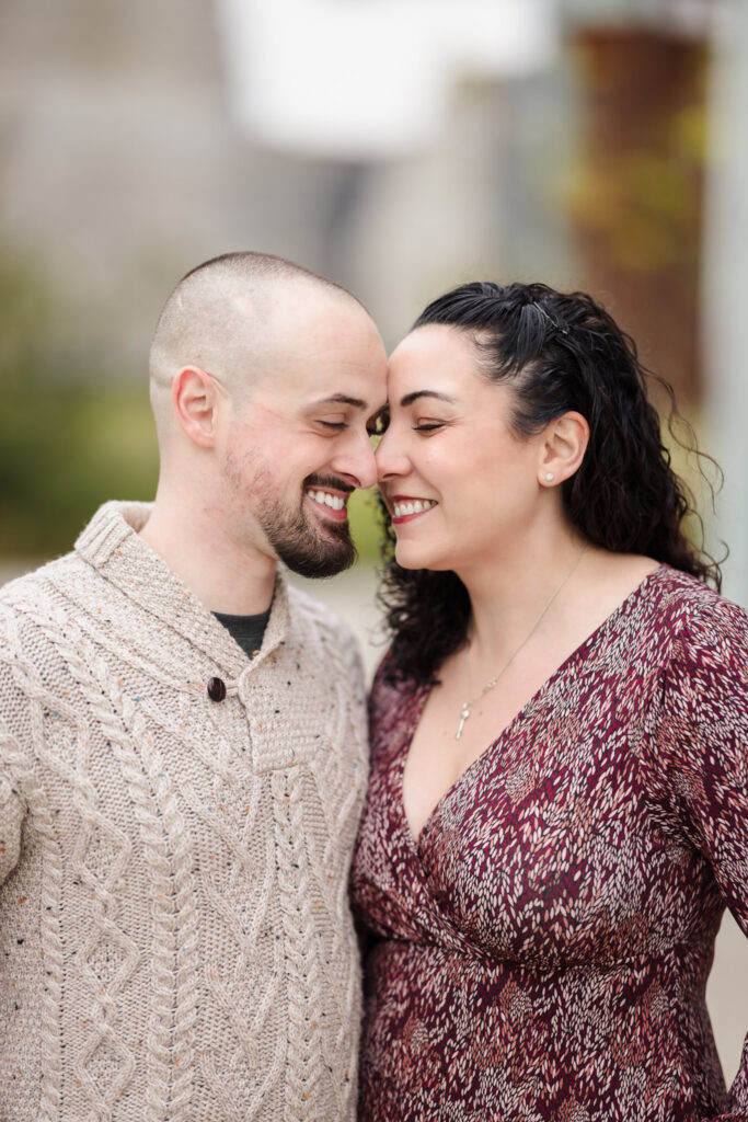 Close-up of couple sharing a quiet smile, captured in soft November morning light with refined NYC portrait styling.