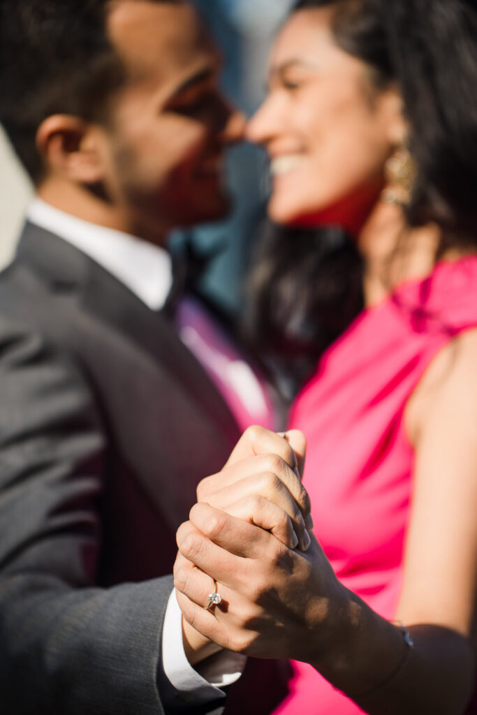 Close-up detail of Mahati’s engagement ring as she and Winston hold hands during, with soft morning light and formal attire creating a refined NYC portrait.
