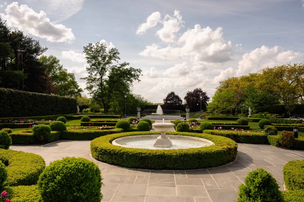 Formal garden with manicured hedges and central fountain at Park Chateau Estate and Gardens in East Brunswick, NJ, a signature setting for a luxury New Jersey wedding venue.