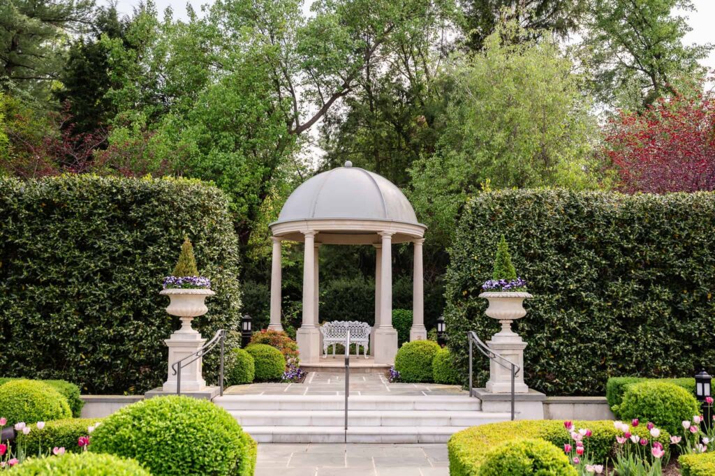Garden gazebo framed by manicured hedges at Park Chateau Estate and Gardens in East Brunswick, NJ, a romantic portrait location for a Park Chateau wedding.