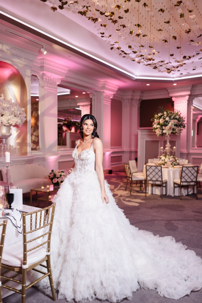 Bridal model wearing a couture wedding gown from Bridal Reflections inside the Garden City Hotel ballroom during the Blush Hour wedding showcase in Garden City, NY.
