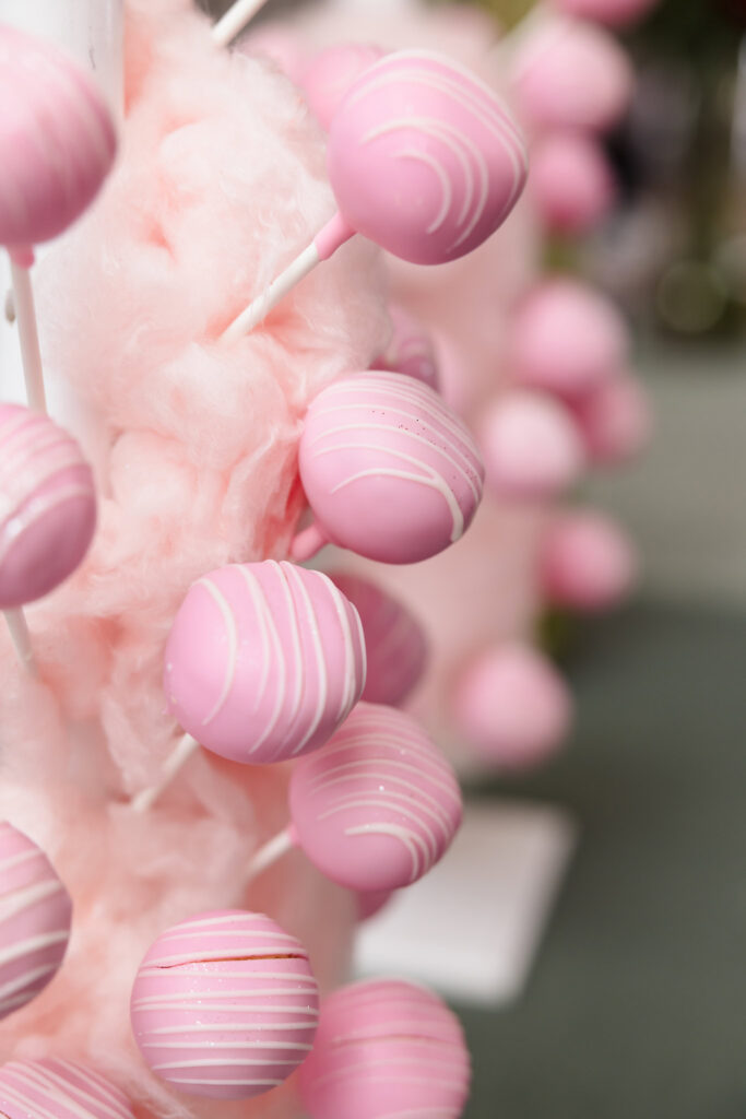 Pink cake pops displayed in cotton candy during the Blush Hour event at the wedding venue in New York.