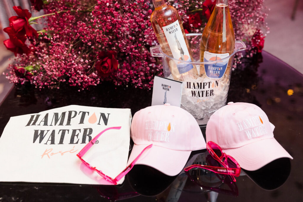 Hampton Water rosé display with branded merchandise and floral décor during the Blush Hour wedding showcase at NY.