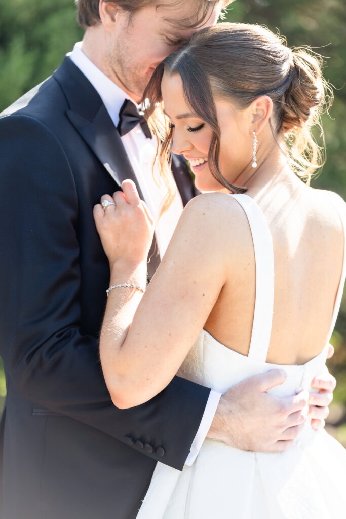 Close portrait of a bride and groom embracing in soft natural light during their Long Island wedding day.