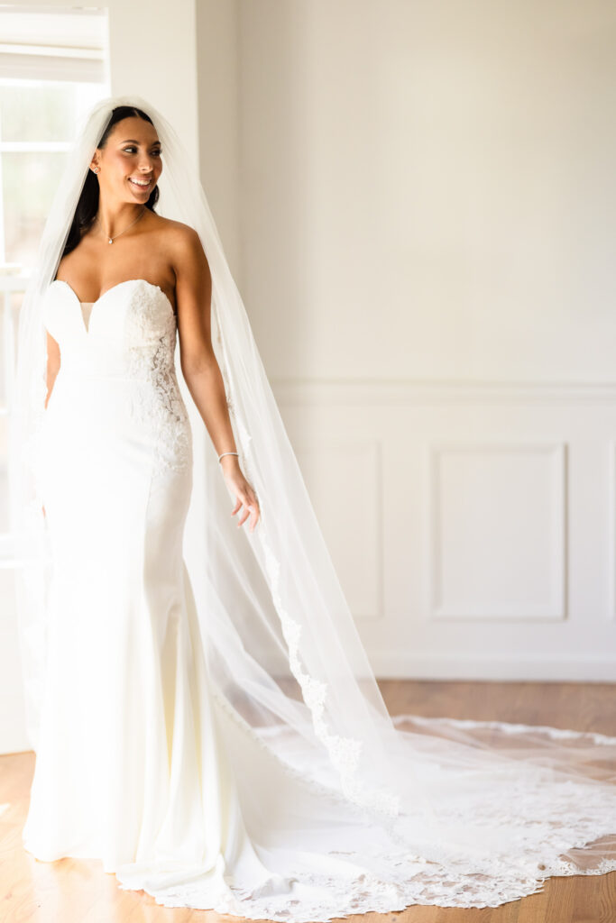 Elegant bridal portrait by a Luxury Wedding Photographer Long Island with soft window light highlighting a classic wedding gown and veil