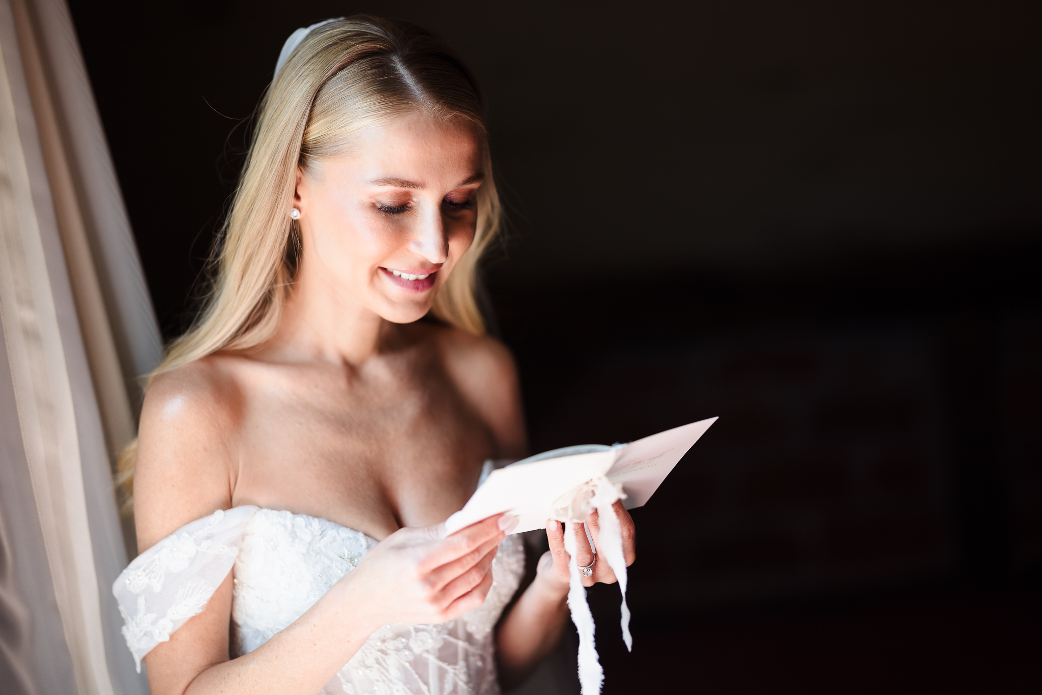 Emotional bridal moment captured by a Luxury Wedding Photographer Long Island as a bride reads a heartfelt letter on her wedding morning