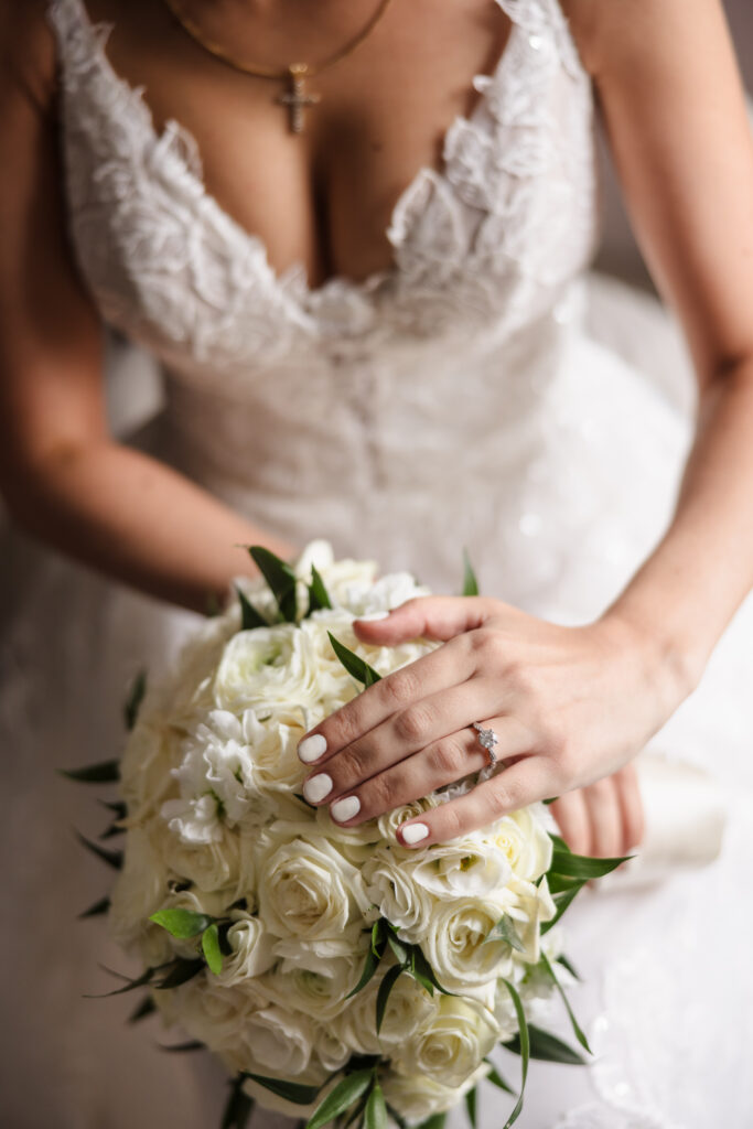 Bridal bouquet and engagement ring detail with soft, romantic natural light