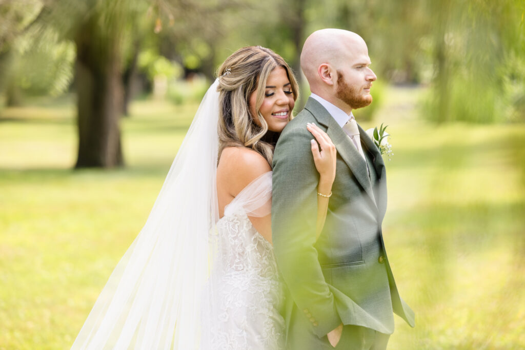 Romantic couple portrait surrounded by soft greenery and natural light