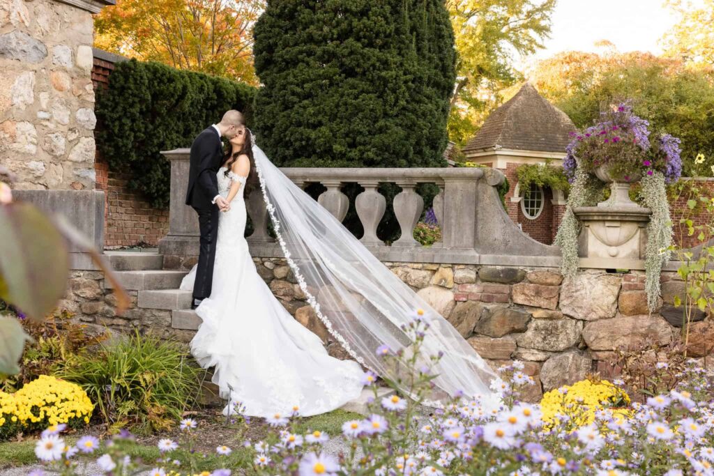 Luxury wedding photographer capturing a romantic veil portrait of a bride and groom at Garden City Hotel on Long Island.