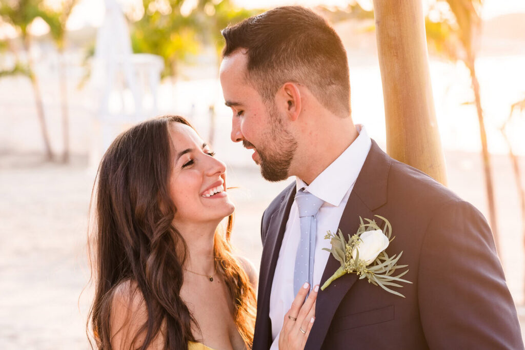 Sunset beach engagement portrait captured by a luxury wedding photographer on Long Island featuring an elegant couple during golden hour