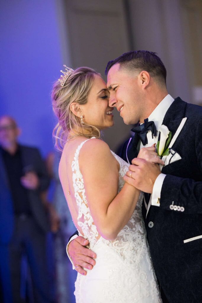 Emotional first dance photographed by a luxury wedding photographer during an elegant Long Island wedding reception.