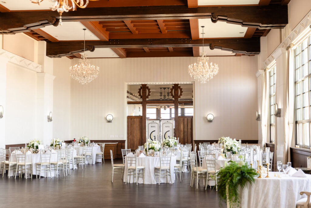 Reception ballroom prepared for a 1920s wedding on Long Island at Gatsby on the Ocean with elegant floral arrangements and classic decor.