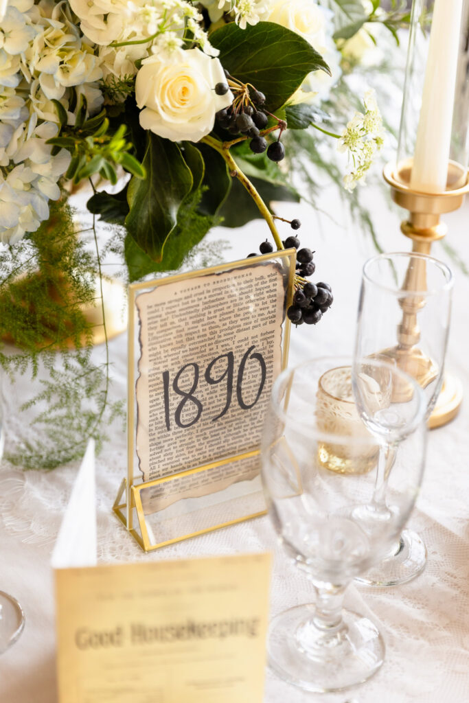 Vintage-inspired centerpiece with florals, candlelight, and antique-style table numbers at a 1920s wedding on Long Island.