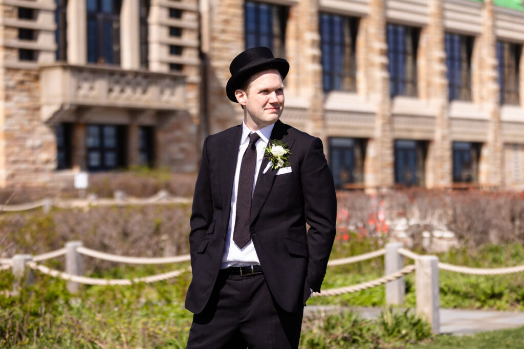 Groom wearing a vintage top hat outside the venue during a 1920s wedding Long Island portrait session.