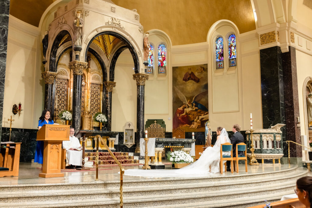 Ashley and Kyle participate in their wedding ceremony at St. Joseph's Church in Garden City.