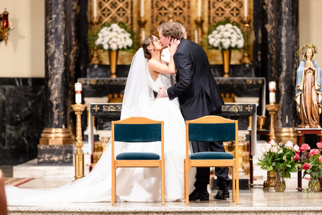Ashley and Kyle share their first kiss as husband and wife during their ceremony at St. Joseph's Church in Garden City.