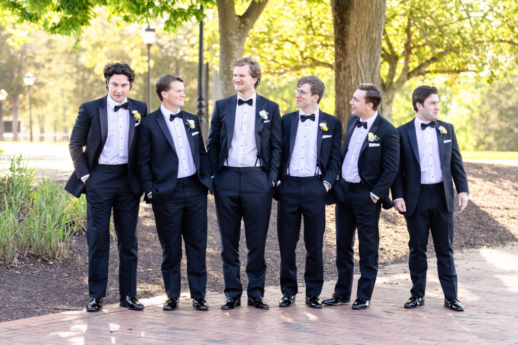 Kyle and his groomsmen pose together outdoors at The Heritage Club at Bethpage before the wedding reception.