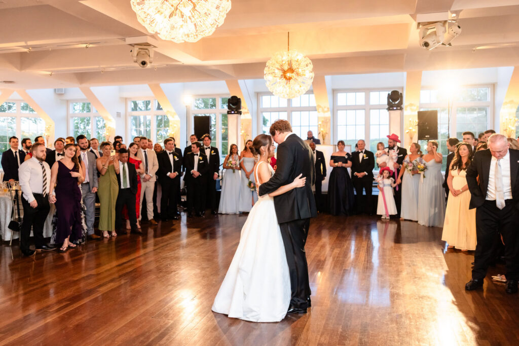 Ashley and Kyle share their first dance surrounded by family and friends in the reception ballroom at The Heritage Club at Bethpage.