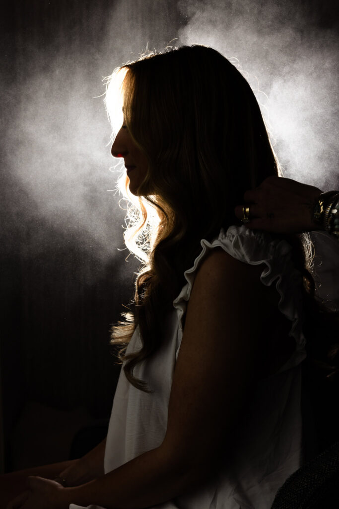 Bride having her hair finished during the getting-ready moments before her Huntington Crescent Club wedding.