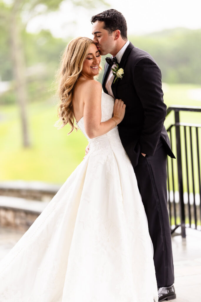 Romantic portrait of the bride and groom sharing a quiet embrace during their Huntington Crescent Club wedding.
