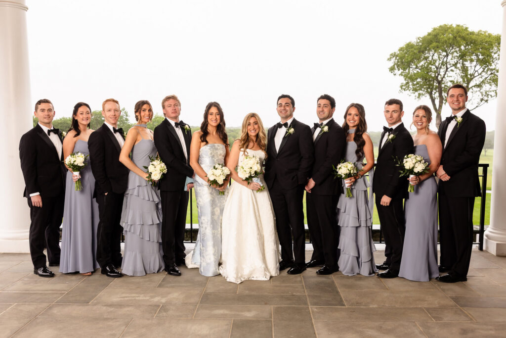 Full bridal party portrait featuring the bride, groom, bridesmaids, and groomsmen during a Huntington Crescent Club wedding.