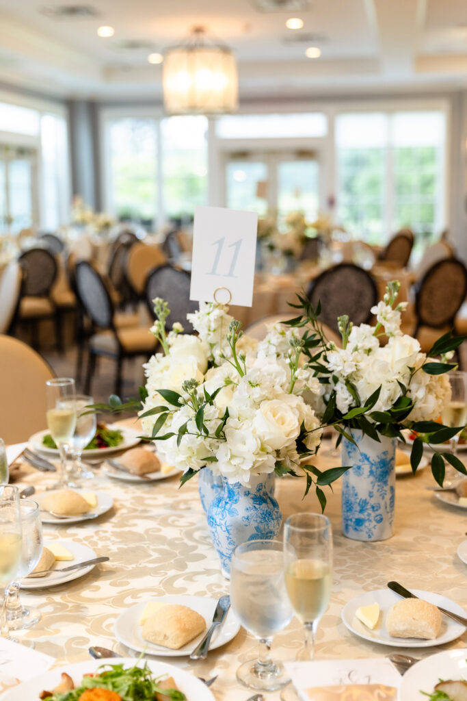 Blue and white floral centerpiece decorating a reception table at a Huntington Crescent Club wedding.
