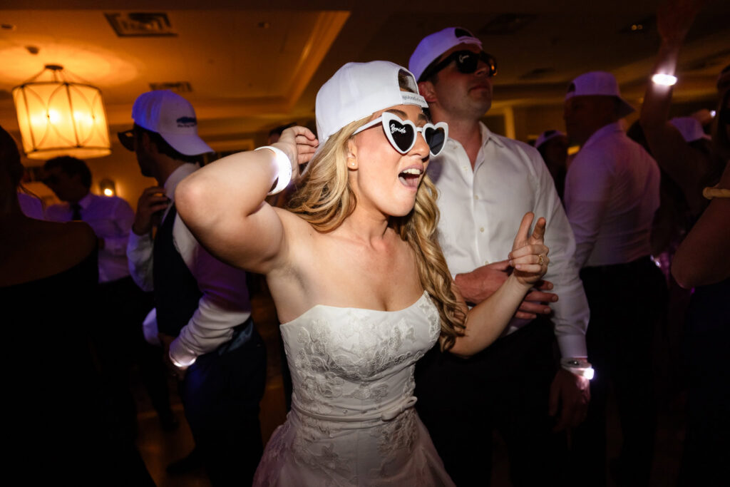 Bride wearing heart-shaped sunglasses and dancing during the after-party.