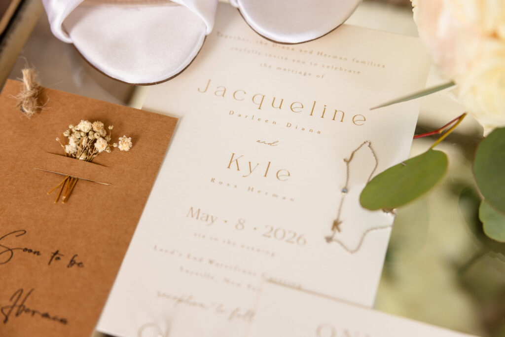 Elegant wedding invitation and bridal details photographed.