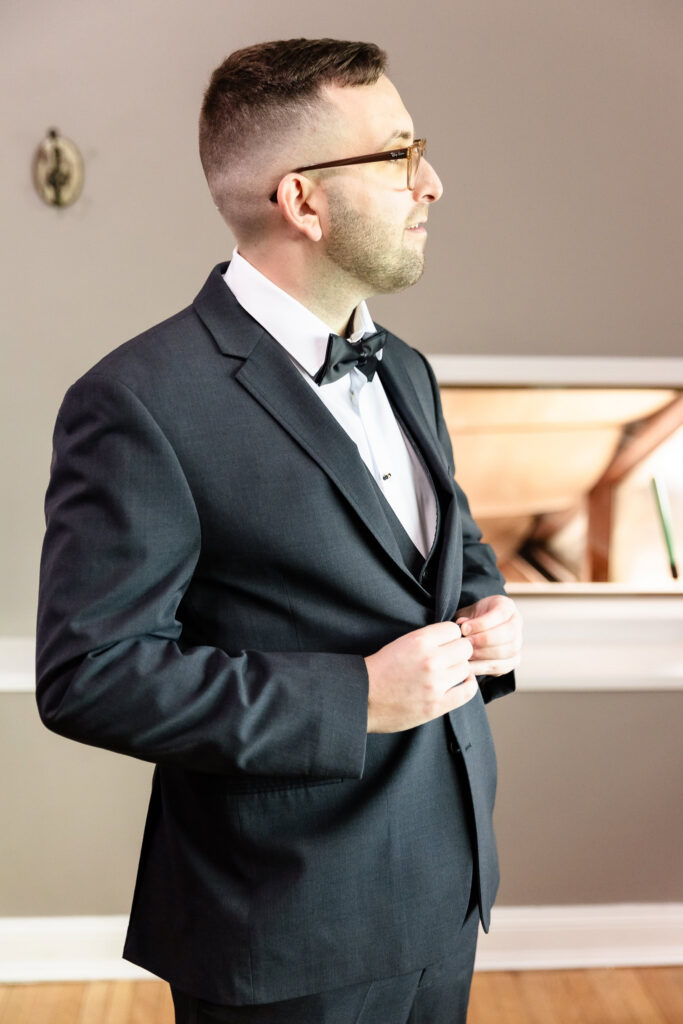 Groom preparing for his ceremony during a spring wedding at Land's End waterfront venue.