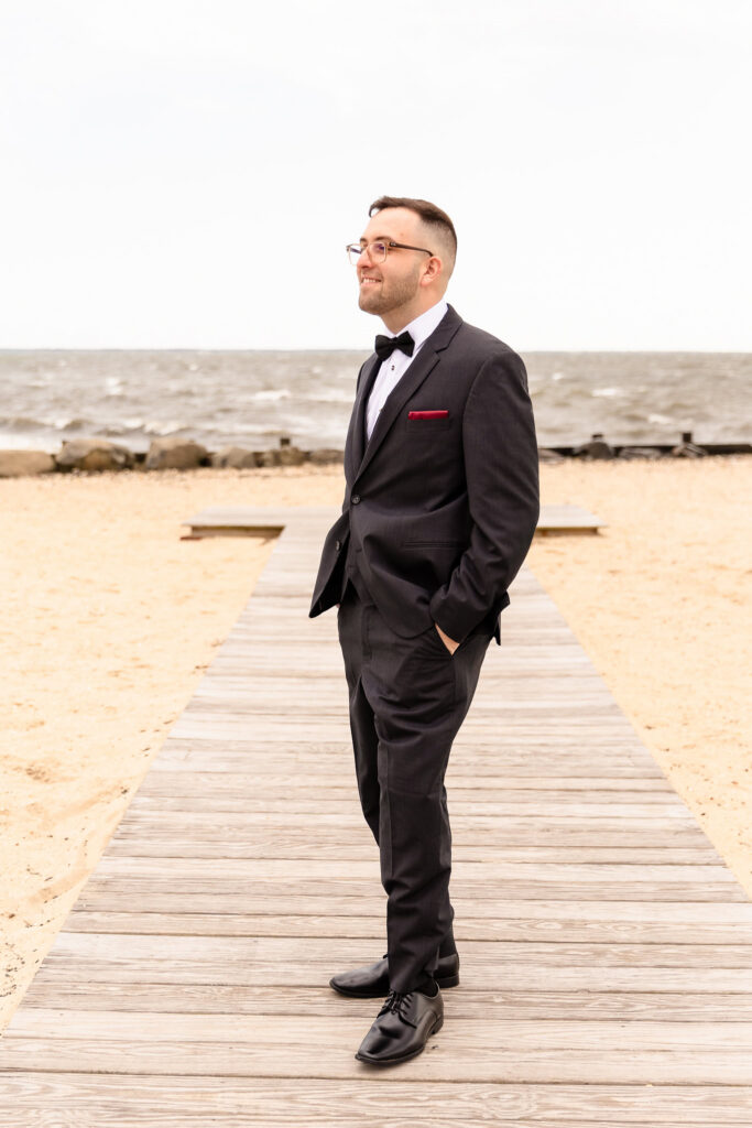 Groom portrait overlooking the waterfront during a spring wedding at Land's End.