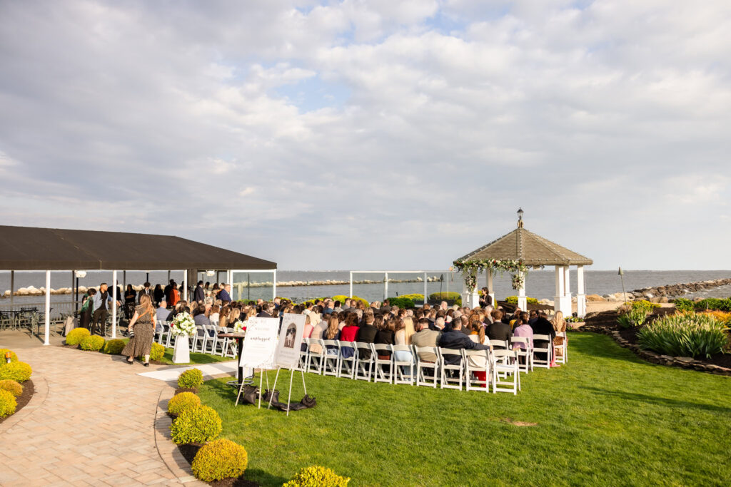 Guests seated for an outdoor ceremony during a spring wedding at Land's End overlooking the Great South Bay in Sayville, New York.