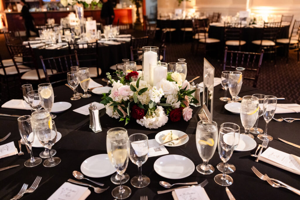 Romantic floral and candle centerpiece displayed at a reception table.