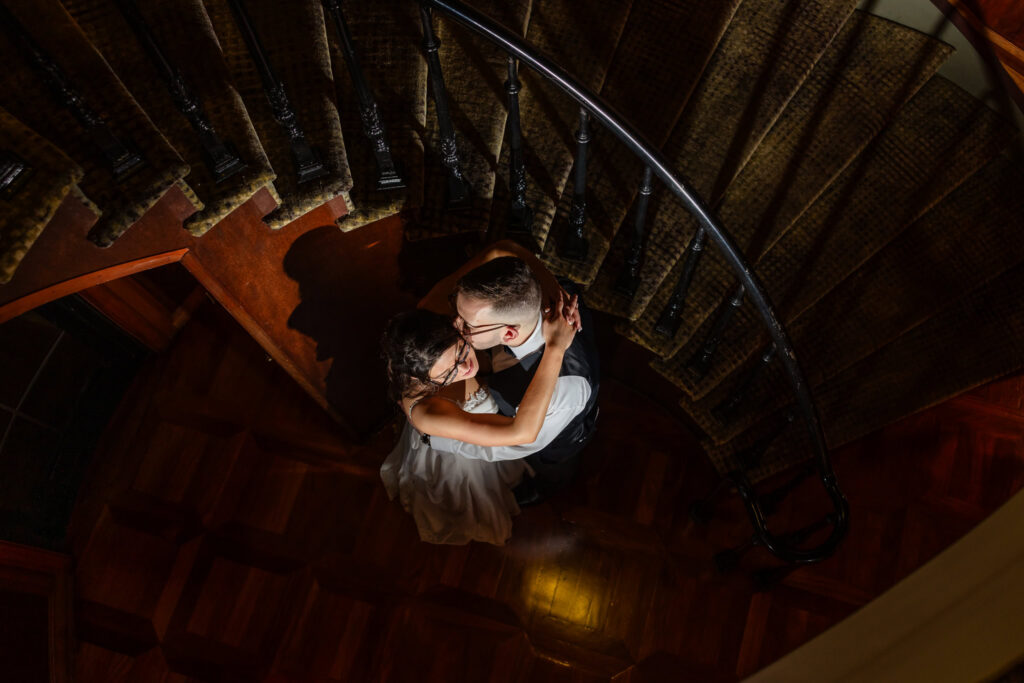 Overhead night portrait of the bride and groom on the staircase at Land's End.