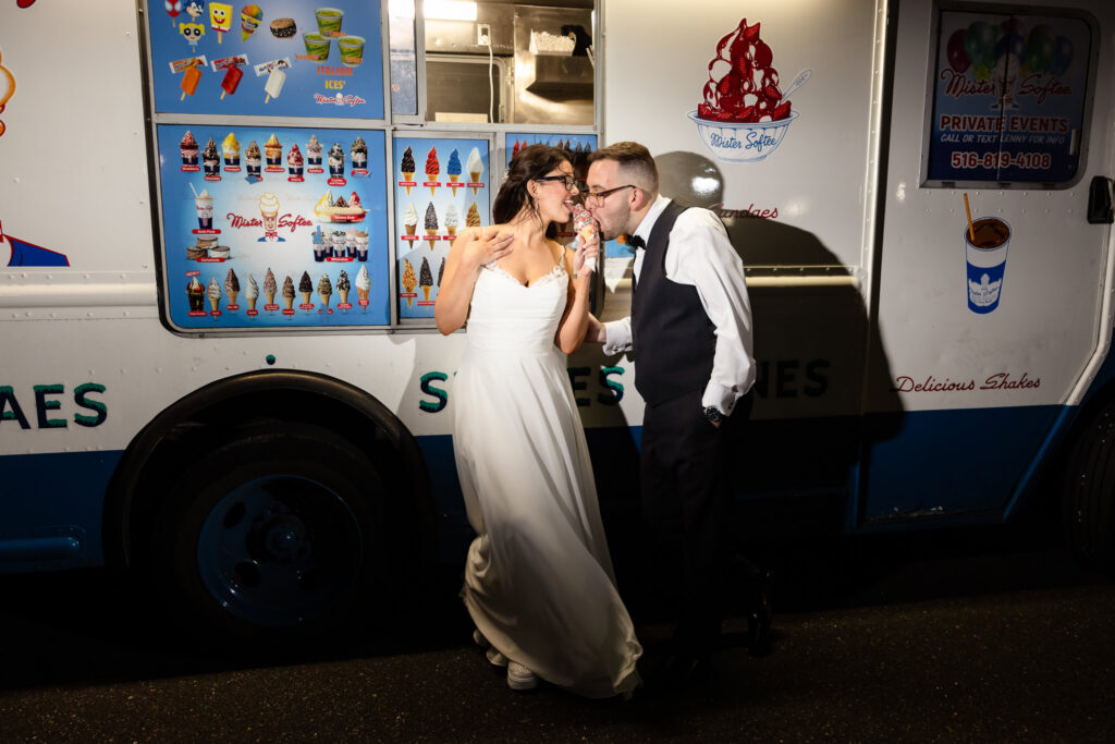Bride and groom enjoying ice cream from a truck.