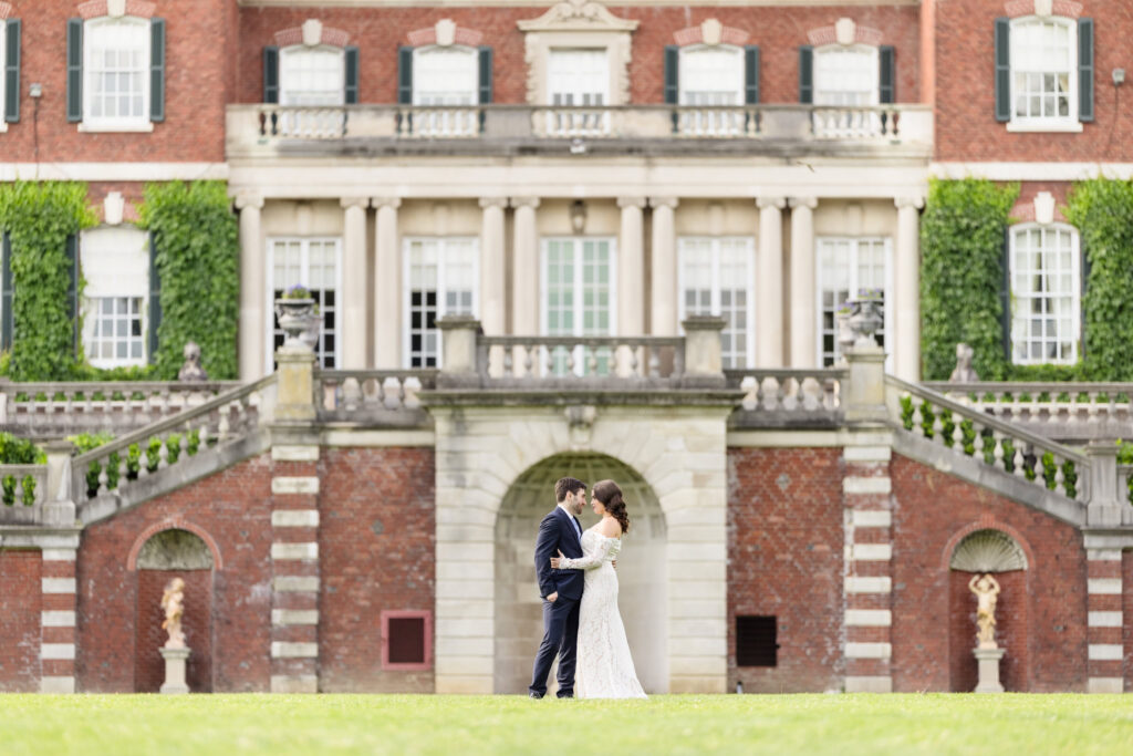 Couple standing together in front of Westbury House during an editorial Old Westbury Gardens engagement session.