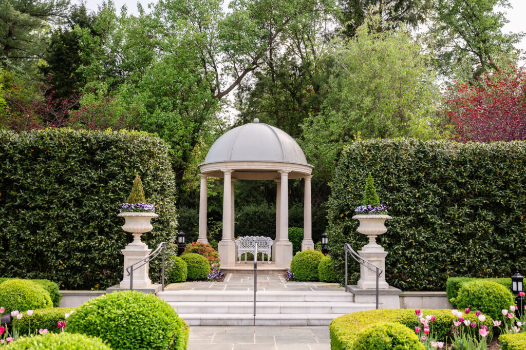 Garden gazebo surrounded by manicured landscaping.