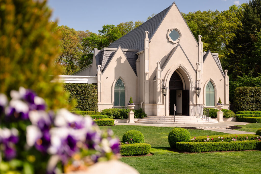 Chapel exterior surrounded by manicured gardens.