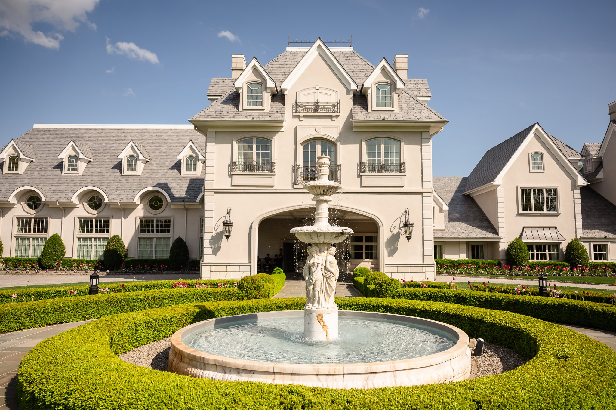 Estate entrance and fountain showcasing the architectural symmetry of a Park Chateau Wedding venue.