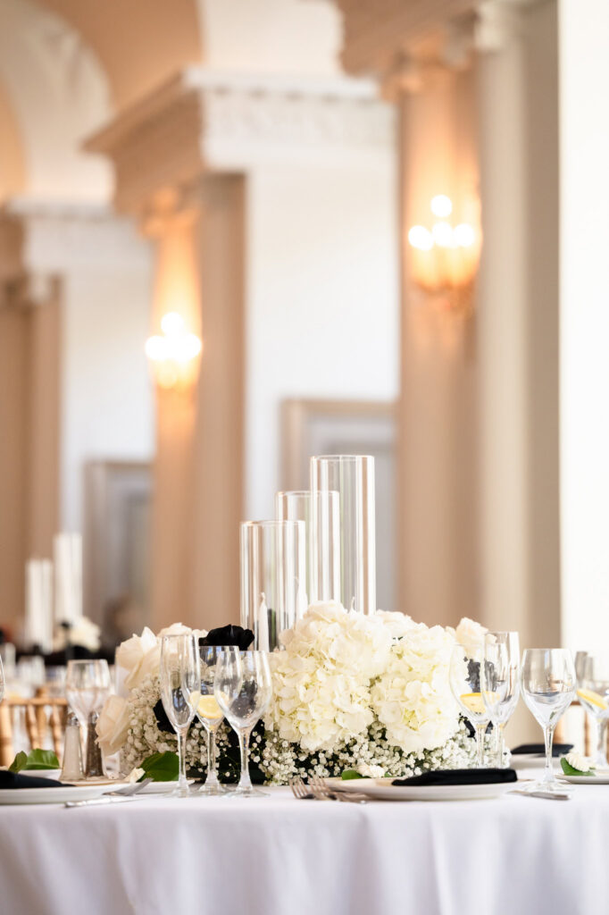 Reception table centerpiece with white florals and candle accents at a Park Chateau Wedding ballroom reception.