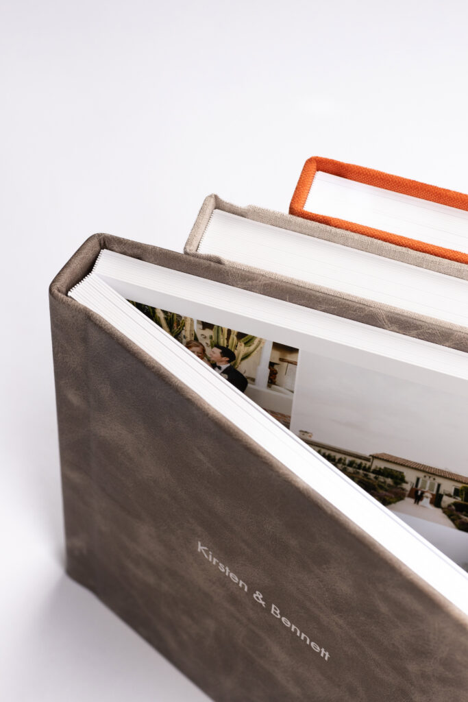Luxury heirloom wedding albums in premium leather and linen covers illustrating why wedding albums matter for preserving wedding memories.