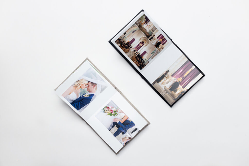 Two open wedding albums with thoughtfully designed spreads that illustrate why wedding albums matter for preserving your wedding story.