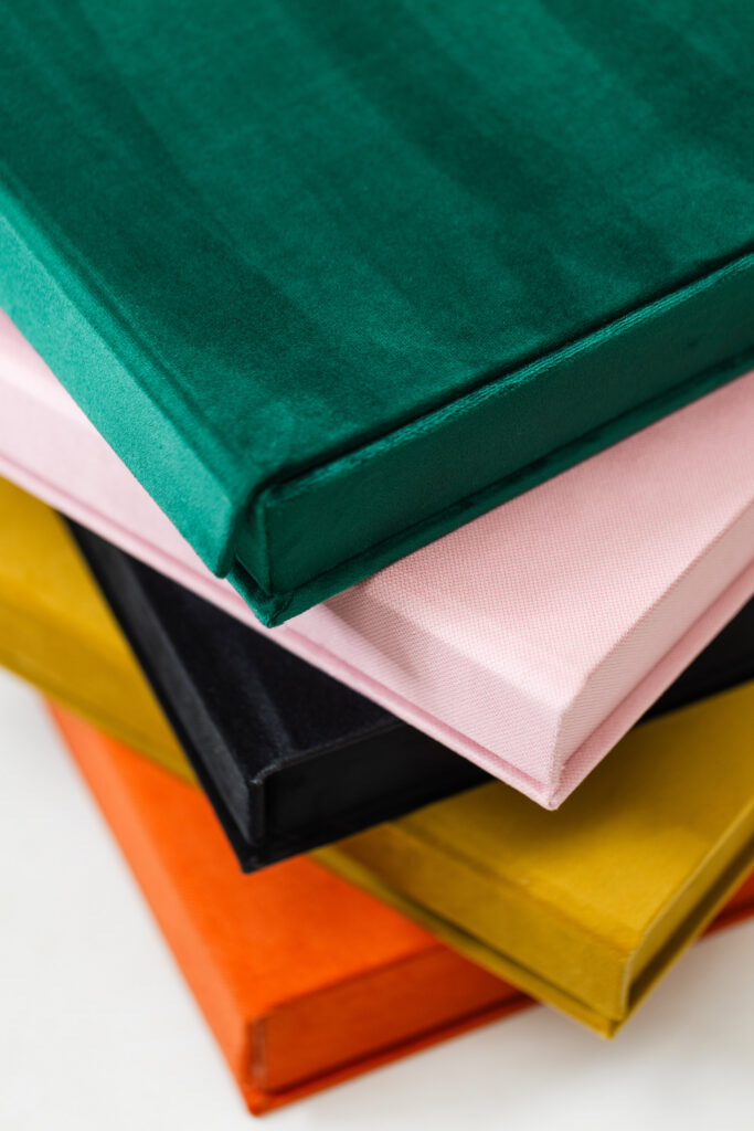 Linen wedding albums in a variety of colors, showcasing why wedding albums matter when creating a personalized heirloom.