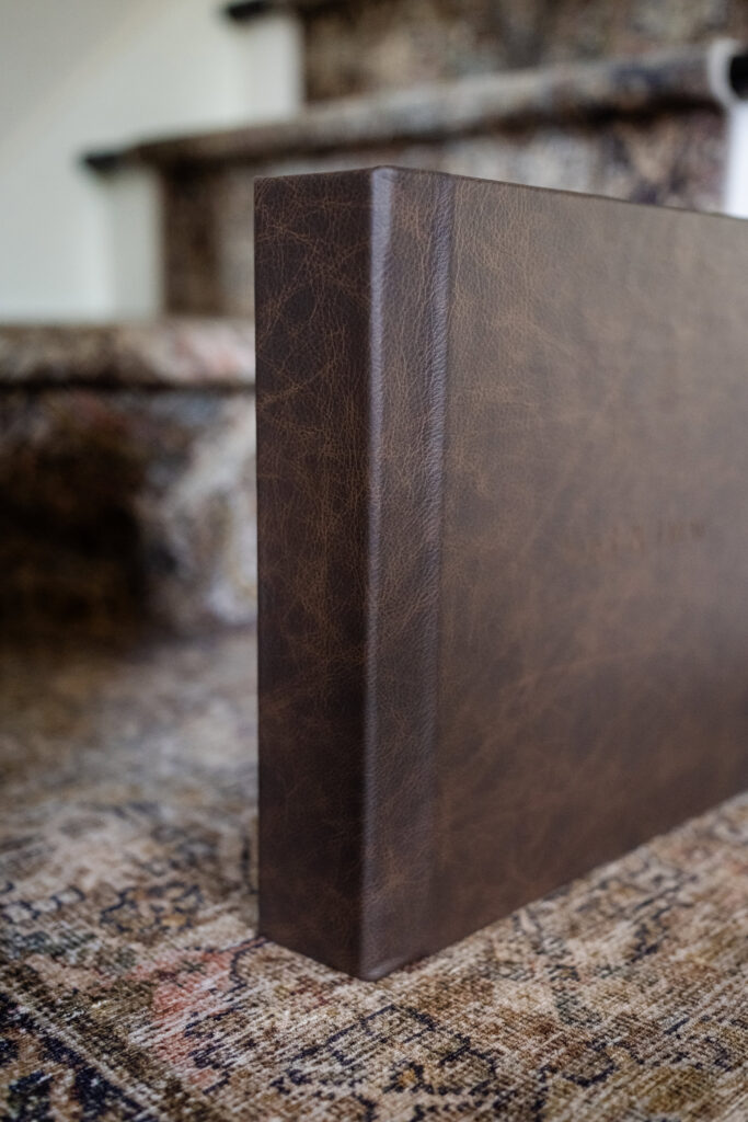 Handcrafted leather album standing upright.