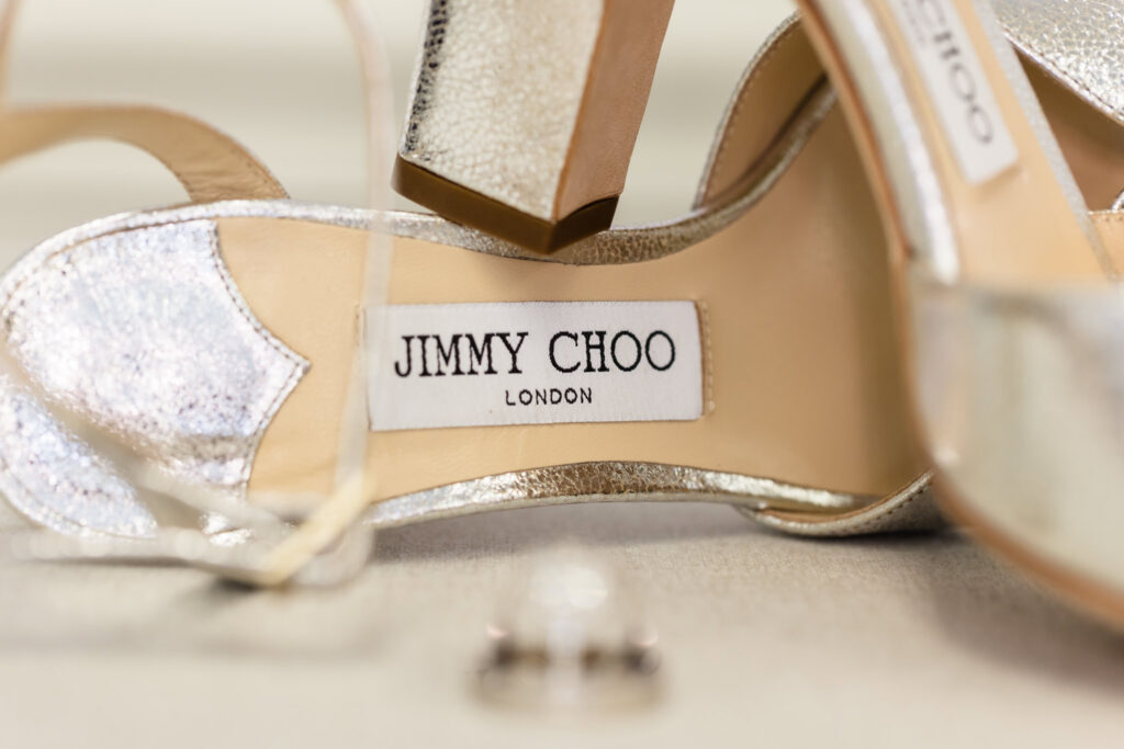 Close-up of Lydia's silver Jimmy Choo wedding shoes photographed as part of her bridal details.