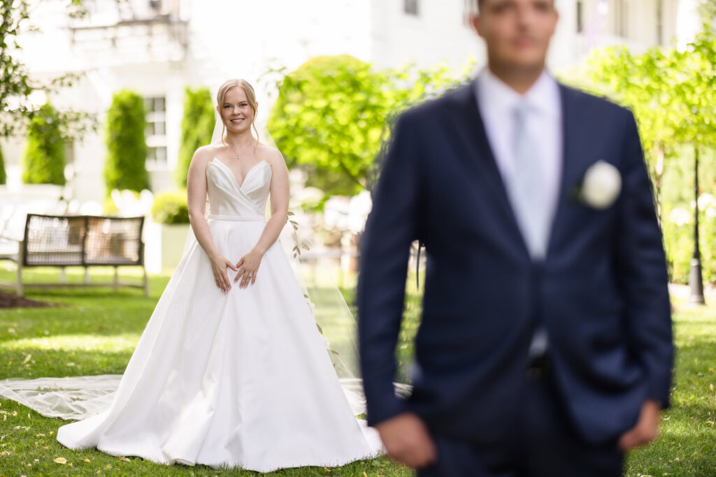 Lydia approaches Robbie for their first look on the grounds of Briarcliff Manor before the ceremony.