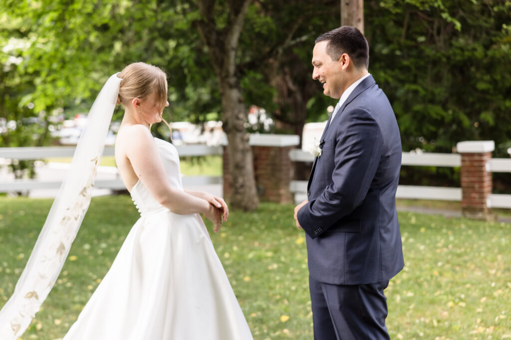 Lydia and Robbie smile as they see each other for the first time during their private first look at Briarcliff Manor.