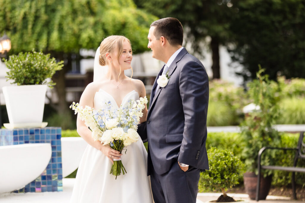 Lydia and Robbie share a quiet portrait together while Lydia holds her blue and white wedding bouquet.