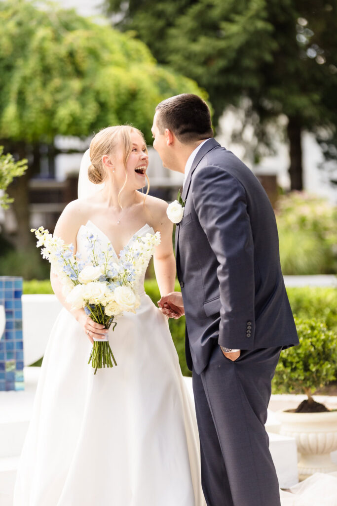 Lydia laughs with Robbie during a joyful portrait session following their first look at Briarcliff Manor.
