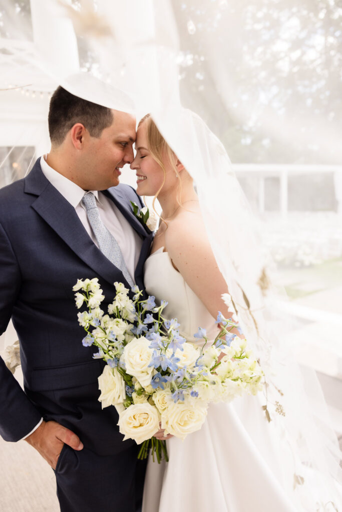 Romantic close-up portrait of Lydia and Robbie beneath her embroidered veil at Briarcliff Manor, highlighting their joyful connection.