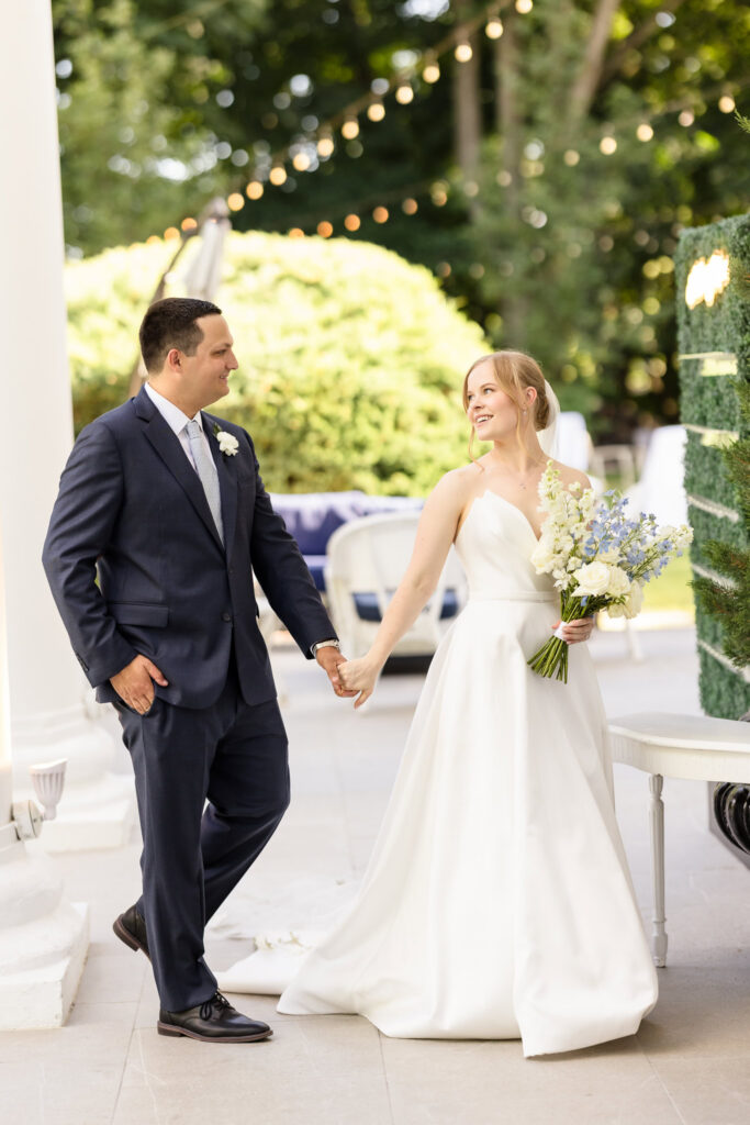 Lydia and Robbie share a joyful first look while holding hands on the porch at The Briarcliff Manor before their wedding ceremony.